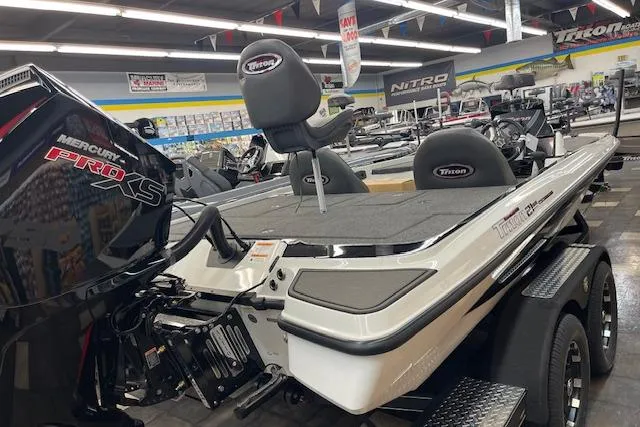 Slide: The Image of 2025 Triton 21XP Patriot boat with Mercury Pro XS engine in showroom. - 3