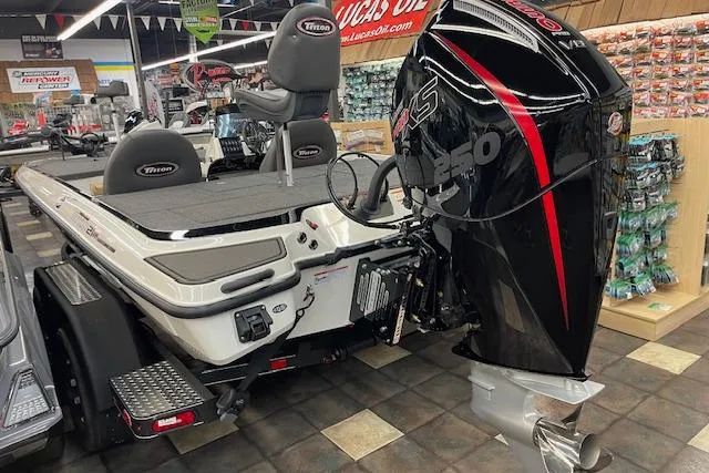 Slide: The Image of 2025 Triton 21XP Patriot boat with powerful engine, displayed in a showroom. - 5