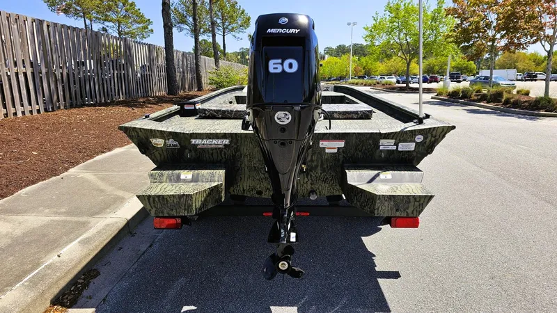 Slide: The Image of 2025 Tracker Grizzly 1860 CC boat with Mercury 50 engine, parked outdoors. - 3