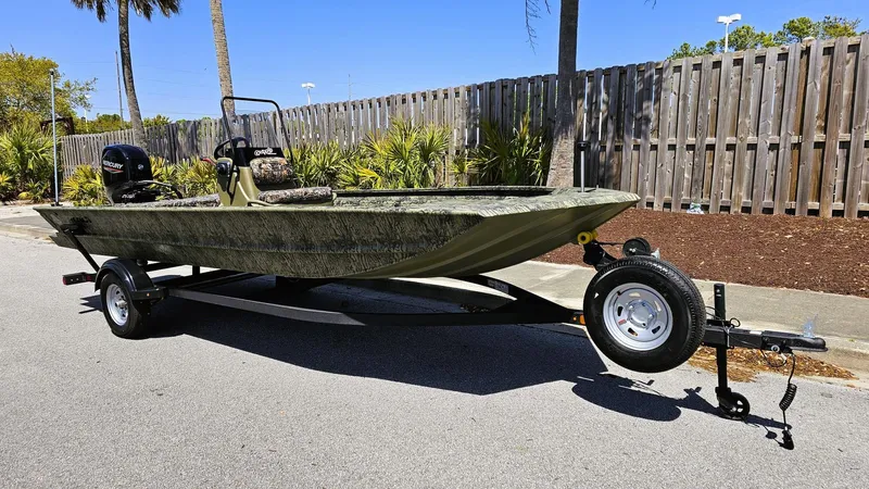 Slide: The Image of 2025 Tracker Grizzly 1860 CC boat on trailer, parked on street, sunny day. - 4