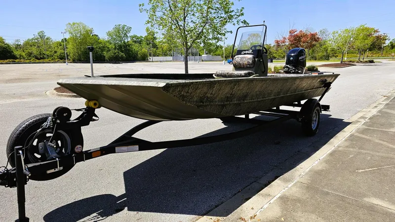 Slide: The Image of 2025 Tracker Grizzly 1860 CC boat on trailer in sunny parking lot. - 5