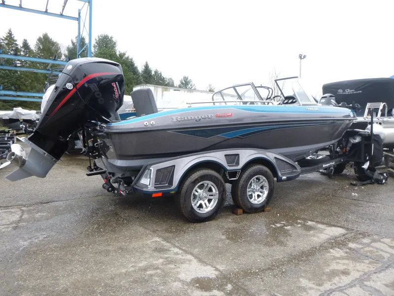 Slide: The Image of 2024 Ranger 1880MS boat on trailer, featuring sleek design and powerful outboard motor. - 3