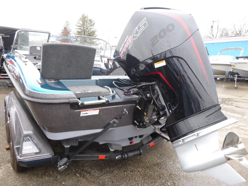 Slide: The Image of 2024 Ranger 1880MS boat with powerful outboard motor, parked on a trailer. - 4