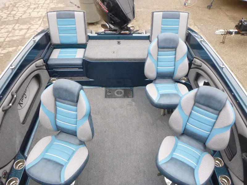 Slide: The Image of 2024 Ranger 1880MS boat interior with blue and gray seating, showcasing spacious design. - 6