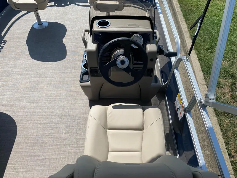 Slide: The Image of 2025 Sun Tracker Bass Buggy 16 XL Select boat interior with steering console and seating. - 6