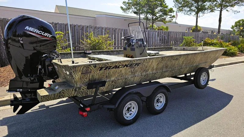 Slide: The Image of 2025 Tracker Grizzly 2072 CC boat on trailer with Mercury outboard motor. - 2