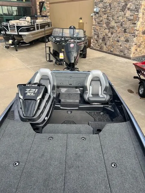 Slide: The Image of 2025 Nitro Z21 XL Pro boat with dual seats and sleek design in showroom. - 10