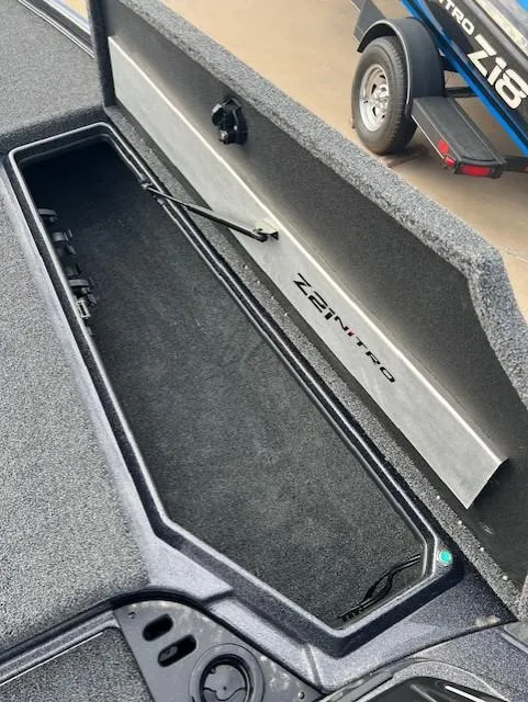 Slide: The Image of 2025 Nitro Z21 XL Pro boat storage compartment, open lid, interior view. - 13