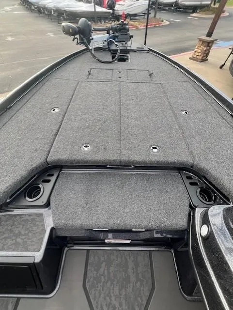 Slide: The Image of 2025 Nitro Z21 XL Pro boat deck with gray carpeting and storage compartments. - 14