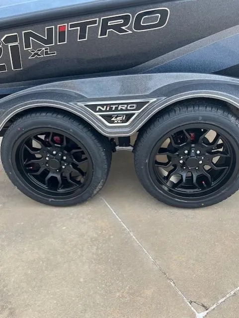 Slide: The Image of 2025 Nitro Z21 XL Pro trailer with black alloy wheels on concrete surface. - 20