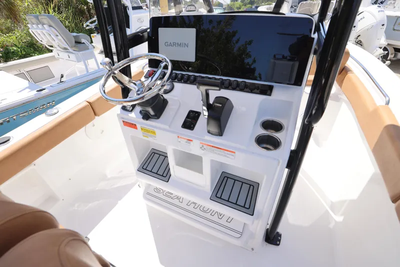 Slide: The Image of 2023 Sea Hunt Ultra 219 boat console with Garmin display and steering wheel. - 2