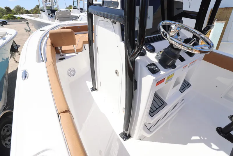 Slide: The Image of 2023 Sea Hunt Ultra 219 boat interior with steering console and seating. - 5