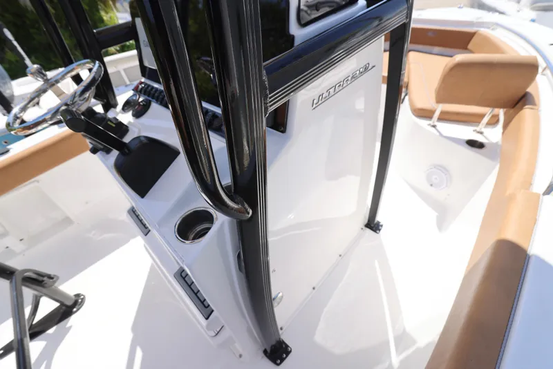 Slide: The Image of 2023 Sea Hunt Ultra 219 boat interior with steering console and seating. - 6