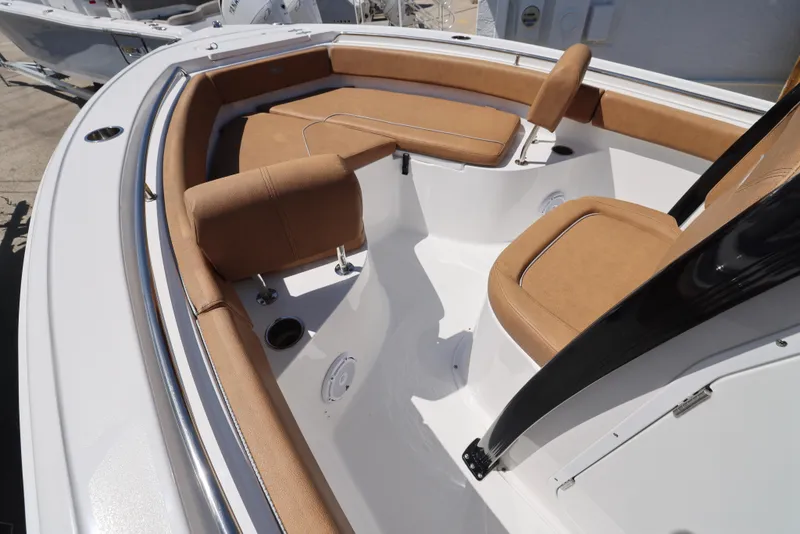Slide: The Image of 2023 Sea Hunt Ultra 219 boat interior with tan seating and sleek design. - 7