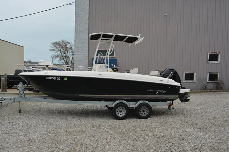 Slide: The Image of 2021 Bayliner Element F21 boat on trailer, parked outdoors. - 0