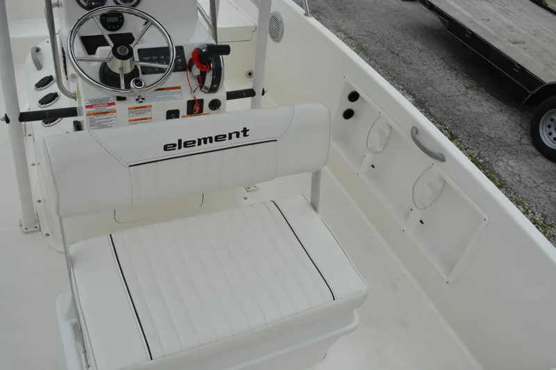 Slide: The Image of 2021 Bayliner Element F21 boat interior with steering wheel and seating. - 11