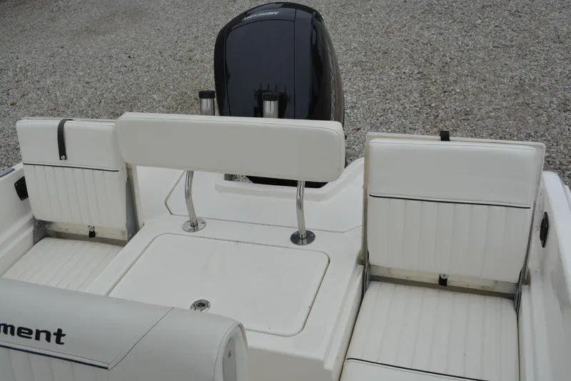 Slide: The Image of 2021 Bayliner Element F21 boat interior with white seating and motor. - 12