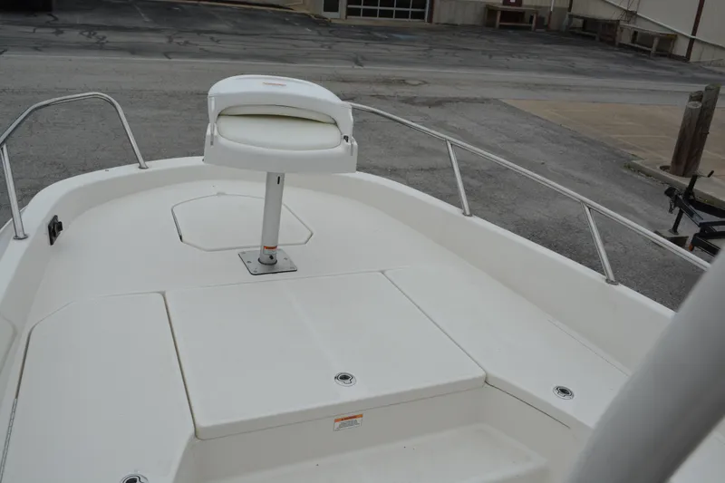 Slide: The Image of 2021 Bayliner Element F21 boat deck with seating and storage compartments. - 15