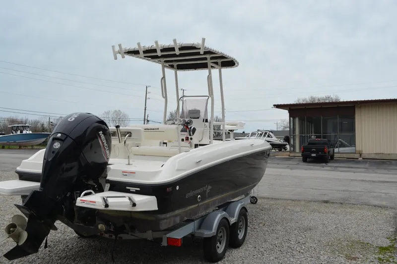 Slide: The Image of 2021 Bayliner Element F21 boat on trailer, parked outdoors. - 5