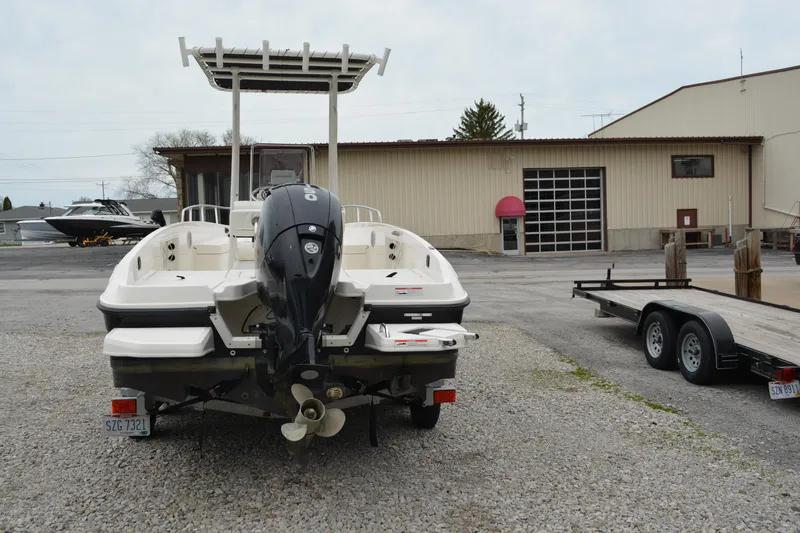 Slide: The Image of 2021 Bayliner Element F21 boat with outboard motor in a marina setting. - 6