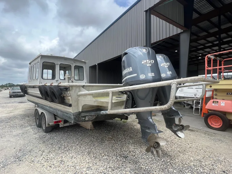 Slide: The Image of Custom Flat 28 Cabin Boat 2010 with dual Yamaha 250 engines on a trailer. - 4