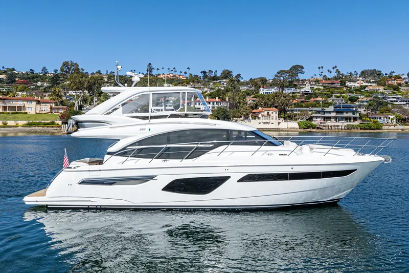 Slide: The Image of Luxury 2022 Princess F55 yacht cruising on a serene waterfront. - 10