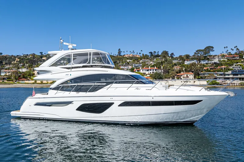 Slide: The Image of 2022 Princess F55 yacht cruising on a sunny day near a coastal town. - 11