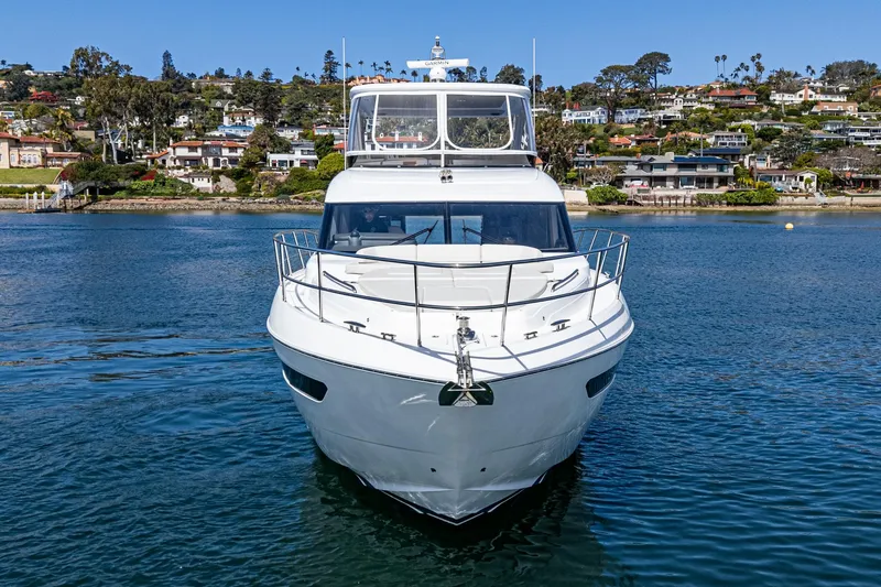 Slide: The Image of 2022 Princess F55 yacht on calm water with scenic coastal background. - 13