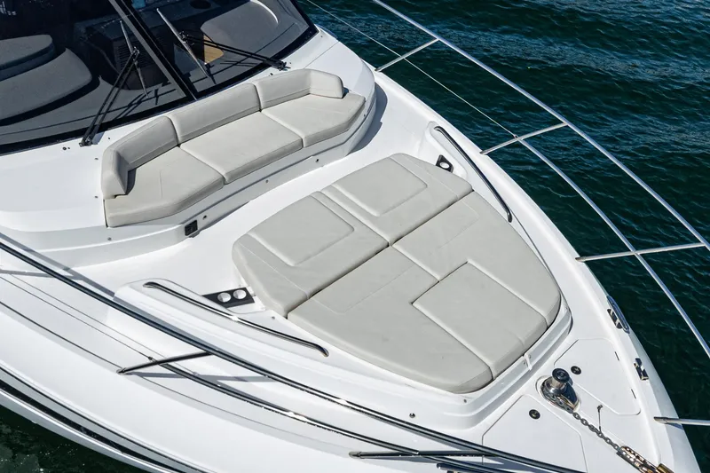 Slide: The Image of Luxury Princess F55 yacht deck with cushioned seating, 2022 model, on calm water. - 15