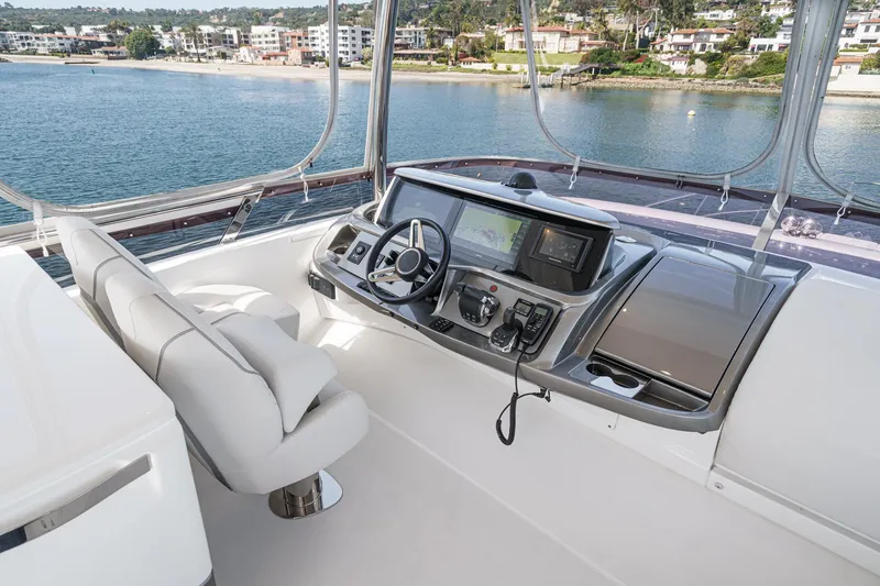 Slide: The Image of Luxurious helm of 2022 Princess F55 yacht with modern controls and scenic waterfront view. - 20