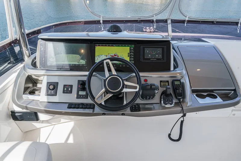Slide: The Image of Control panel of 2022 Princess F55 yacht with steering wheel and navigation screens. - 21
