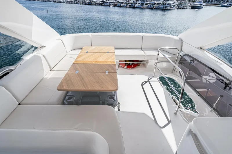 Slide: The Image of Luxurious 2022 Princess F55 yacht deck with seating and table, overlooking marina. - 23
