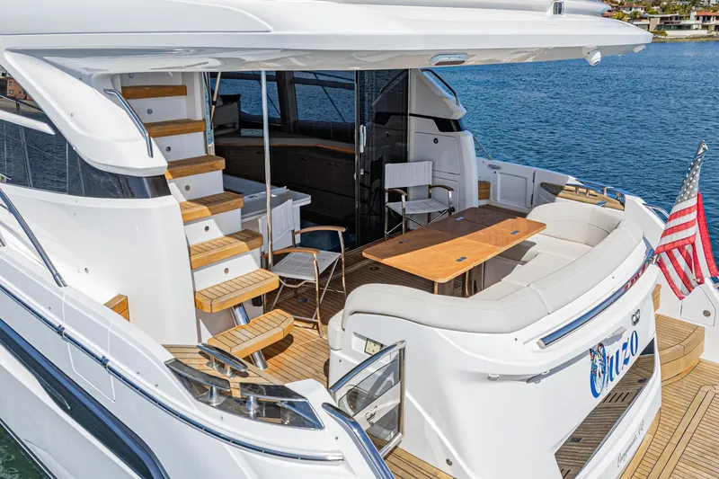 Slide: The Image of Luxurious 2022 Princess F55 yacht with elegant deck seating and wooden stairs. - 27