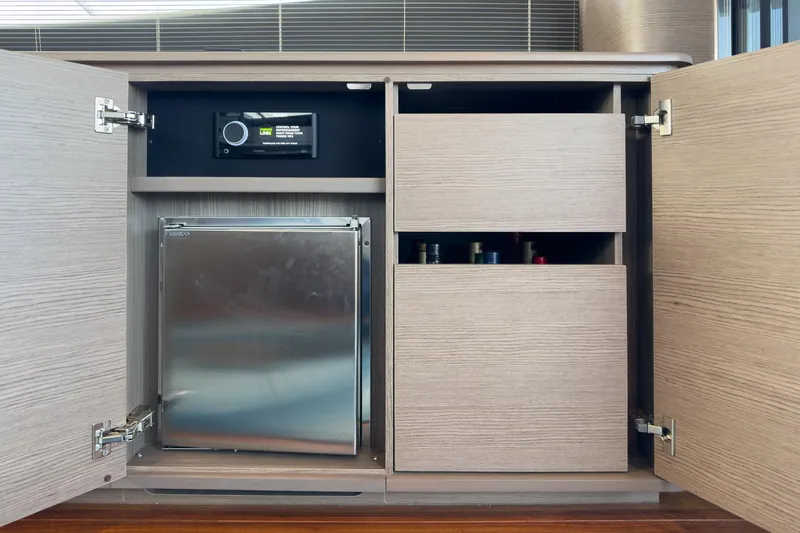 Slide: The Image of Modern yacht interior with cabinets, mini fridge, and control panel, Princess F55, 2022 model. - 43