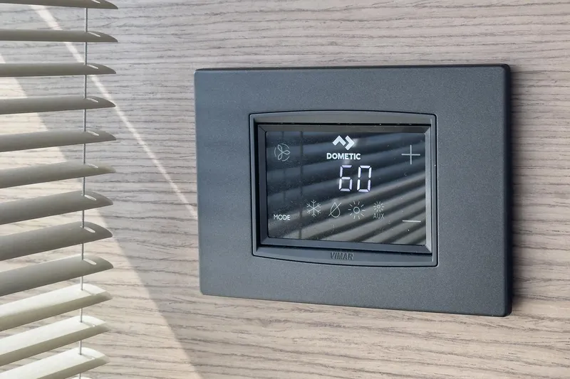 Slide: The Image of Thermostat on Princess F55 yacht, displaying temperature settings, mounted on wooden panel. - 45