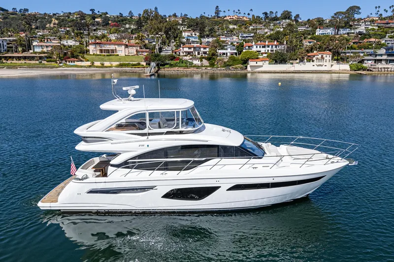 Slide: The Image of 2022 Princess F55 yacht cruising on a serene coastal waterway. - 9