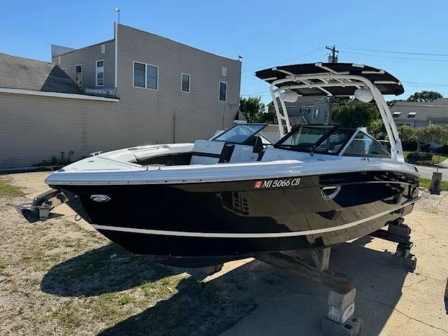Slide: The Image of 2021 Cobalt R8 boat on a trailer, parked outdoors near buildings. - 0