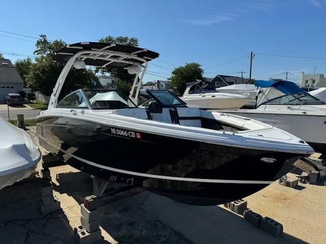 Slide: The Image of 2021 Cobalt R8 boat on display in a marina setting. - 1