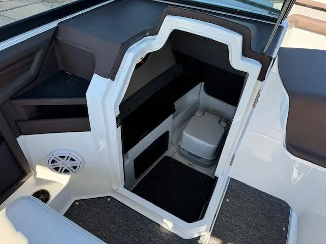 Slide: The Image of 2021 Cobalt R8 boat interior with compact marine toilet and storage area. - 10