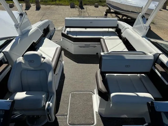Slide: The Image of 2021 Cobalt R8 boat interior with white and brown seating, spacious layout, and modern design. - 12