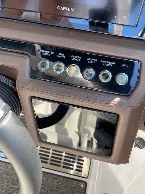 Slide: The Image of Dashboard of a 2021 Cobalt R8 boat with control switches and Garmin display. - 16