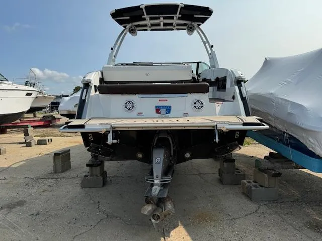 Slide: The Image of 2021 Cobalt R8 boat on blocks, rear view, in a marina setting. - 4