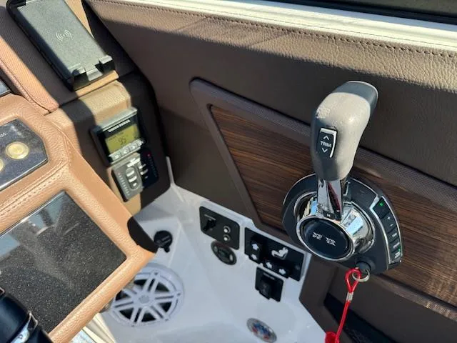 Slide: The Image of Cobalt R8 2021 boat dashboard with controls and brown leather accents. - 9
