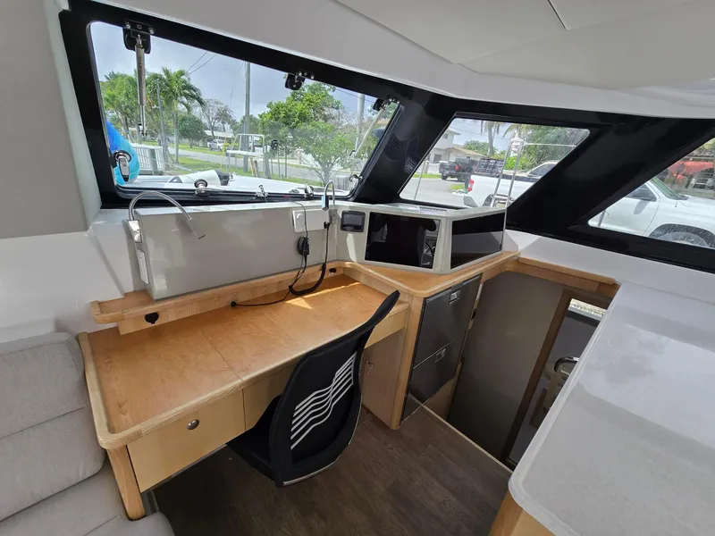 Slide: The Image of Interior of 2025 Seawind 1370 yacht with modern navigation station and large windows. - 11