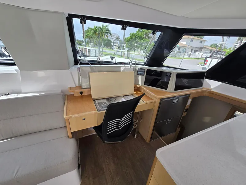 Slide: The Image of Interior of 2025 Seawind 1370 yacht with modern navigation station and seating area. - 12