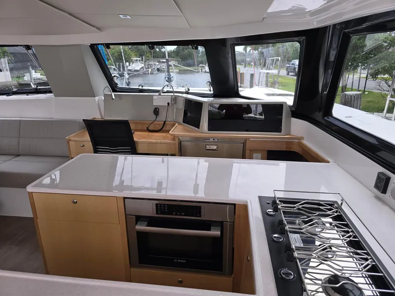 Slide: The Image of Modern Seawind 1370 yacht interior with sleek kitchen and panoramic windows, 2025 model. - 13
