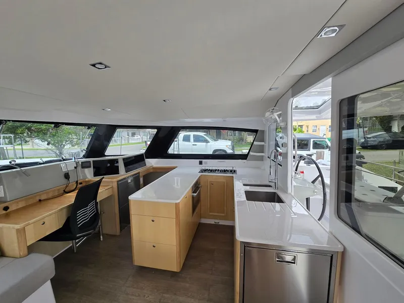 Slide: The Image of Modern interior of 2025 Seawind 1370 catamaran with sleek kitchen and work area. - 17