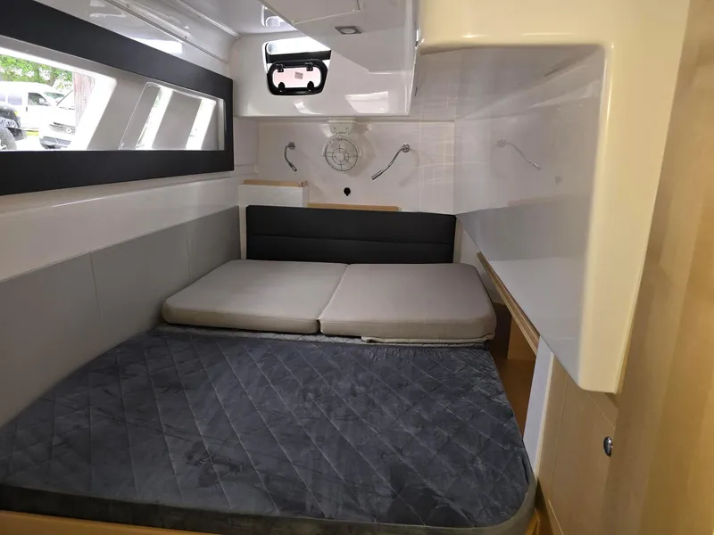 Slide: The Image of Cozy cabin interior of 2025 Seawind 1370 yacht with modern bedding and sleek design. - 19