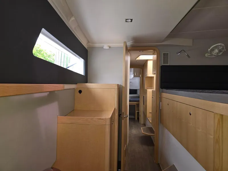 Slide: The Image of Interior of 2025 Seawind 1370 yacht, featuring modern wood cabinetry and sleek design. - 22