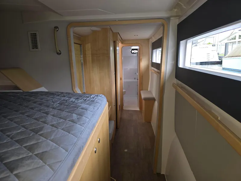 Slide: The Image of Interior of 2025 Seawind 1370 yacht, featuring a cozy cabin with modern design elements. - 25